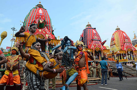 Artistes performing in front of chariots along the Grand Road in Puri on Sunday. (EPS|Biswanath Swain)