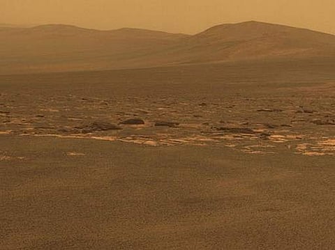 In this image released by NASA, a portion of the west rim of Endeavour crater sweeps southward in this color view from NASA's Mars Exploration Rover Opportunity. | AFP