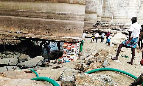 One of the damaged pillars of the Solasiramani barrage-cum-bridge, which has been propped up by sand bags, in Namakkal district; and (below) the pillar with damaged base due to soil erosion before repair work began | Express