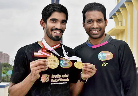 Badminton player Kidambi Srikanth the winner of Indonesian and Australian Open Super Series 2017 poses with coach Gopi Chand in Hyderabad Tuesday. | PTI