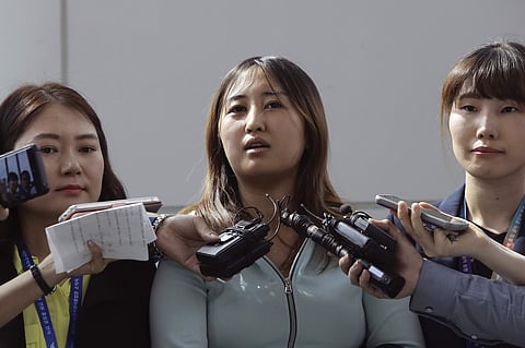 Chung Yoo-ra, centre, answers questions from the media. (File photo | AP)