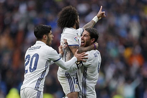 Real Madrid's Marcelo, top, celebrates with teammates Sergio Ramos, right, and Marco Asensio.  (File photo | AP)