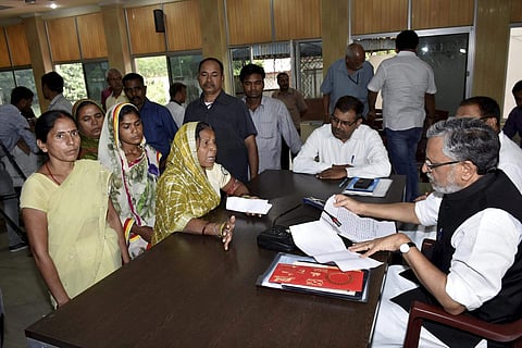 Patna Senior BJP leader Sushil Kumar Modi listening to the grievances of people during a Janta Darbar in Patna on Tuesday. (PTI)