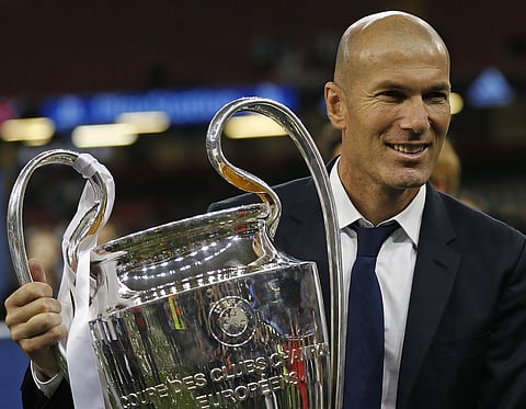 Real Madrid's head coach Zinedine Zidane celebrates with the trophy at the end of the Champions League soccer final between Juventus and Real Madrid at the Millennium Stadium in Cardiff. | AP