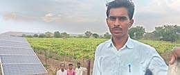 Krishna Mhase of Varud in Jalna district of Maharashtra with his vineyard and newly installed solar system in the background | Express