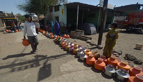 Colourful plastic pots kept in line for drinking water near ShahuChowk, Nanded road in Latur. Express Photo by A Radhakrishna