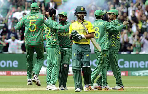 Pakistan players celebrate after Pakistan's Hasan Ali bowled South Africa's JP Duminy, centre, caught Pakistan's Babar Azam for 8 runs during the ICC Champions Trophy match between Pakistan and South Africa at Edgbaston in Birmingham. | AP