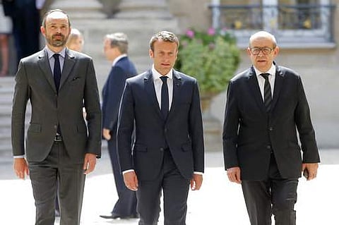 From the left, French Prime Minister Edouard Philippe, French President Emmanuel Macron, and French Foreign Minister Jean-Yves le Drian leave after a visit at the British embassy in Paris | AP