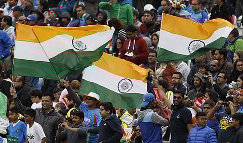 Cricket fans wave India flags during the ICC Champions Trophy match between India and Sri Lanka at The Oval cricket ground in London. | AP