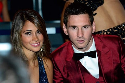 Barcelona's Argentine forward Lionel Messi (R) and his partner Antonella Roccuzzo. | AFP