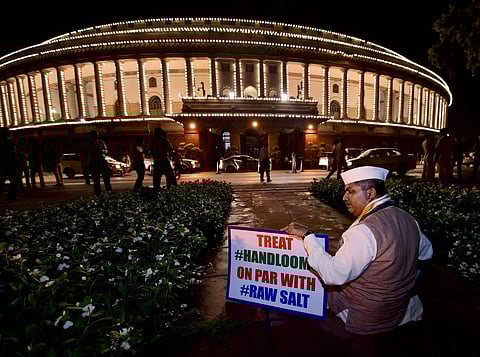 Congress Rajya Sabha MP from Telangana Ananda Bhaskar Rapolu protesting against GST in front of the Gandhi statue in the Parliament complex in New Delhi on Friday ahead of the midnight launch of the tax reform. (PTI)