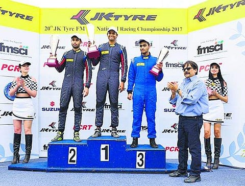 Vishnu Prasad (C) being felicitated by Sanjay Sharma (R) of JK Motorsports.