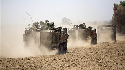 Israeli armored personnel carriers move along the Israel and Gaza border. (File Photo | AP)