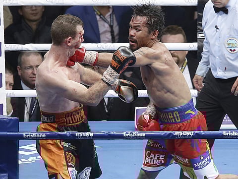 Jeff Horn, left, of Australia and Manny Pacquiao of the Philippines fight during their WBO World welterweight title bout in Brisbane, Australia, Sunday, July 2, 2017. | AP
