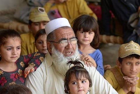(File Photo for representation only | AFP) In this May 20 photograph, Gulzar Khan, who has 36 children from his three wives, is surrounded by his children as he speaks during an interview with AFP at his house in the northwestern town of Bannu.