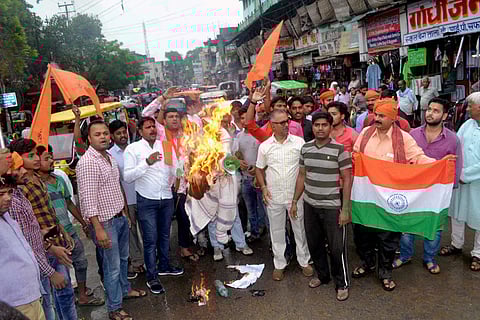 Bajrang Dal and Vishva Hindu Parishad activists raise slogans and burn an effigy during a protest against terrorist attack on Amarnath pilgrims in Varanasi on Tuesday. (PTI)