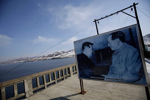 A billboard showing Mao Zedong, right, and North Korea’s founding father, Kim Il-sung, near the China-North Korea border. (AP)