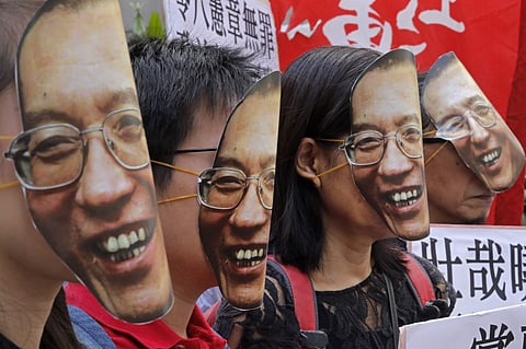 Protesters wear masks of jailed Chinese Nobel Peace laureate Liu Xiaobo during a demonstration outside the Chinese liaison office in Hong Kong, Tuesday, June 27, 2017. (Photo | Associated Press)