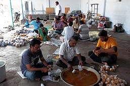 Amudhasurabi volunteers gathered at the kitchen pack food items to be served for destitute in the city and rural areas around Salem town | Express