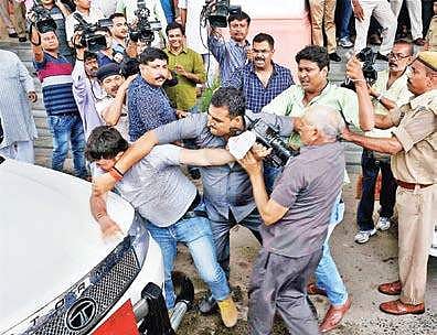 Bihar deputy chief minister Tejaswi Yadav’s security personnel manhandle a media person in Patna on Wednesday| PTI