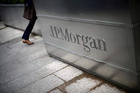 A man walks into the JP Morgan headquarters at Canary Wharf in London May 11, 2012. (Photo | Reuters)