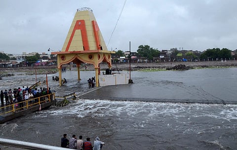 Rajkot People gathered to see flooded aria after heavy rain in Rajkot on Saturday. (PTI)