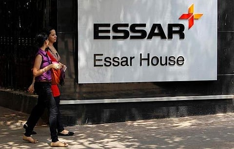 Employees walk past an Essar Group logo outside their headquarters in Mumbai May 20, 2013. (Photo| Reuters)