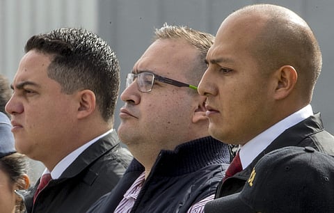 Mexico's former Veracruz state Gov. Javier Duarte, center, is escorted by police to an aircraft as he is extradited to Mexico City, at an Air Force base in Guatemala City. | AP