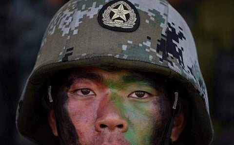 A People's Liberation Army (PLA) of China soldier looks on after participating in an anti-terror drill during the Sixth India-China Joint Training exercise 'Hand in Hand 2016' at HQ 330 Infantry Brigade, in Aundh in Pune district, some 145km southeast of 