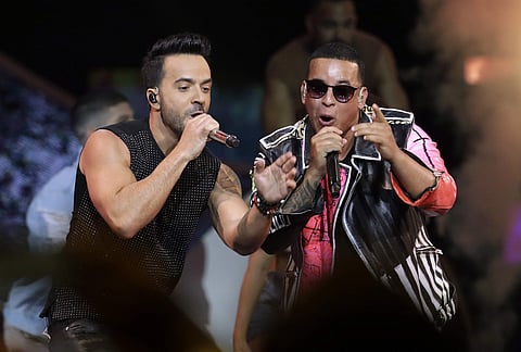 FILE - In this April 27, 2017 file photo, singers Luis Fonsi, left and Daddy Yankee perform during the Latin Billboard Awards in Coral Gables, Fla. Malaysia has banned their hit song 'Despacito' on state radio and television, though it might be hard to sl
