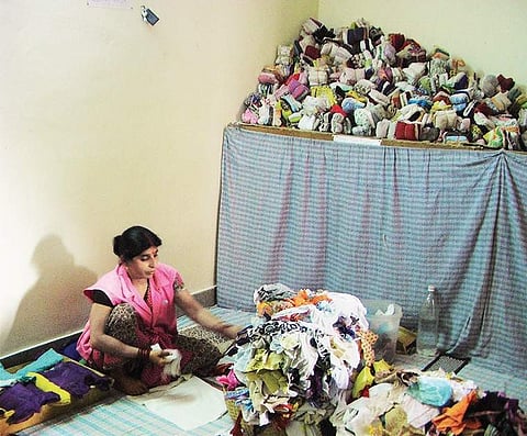 A lady packing sanitary pads made from recycled cloths