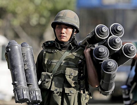 An Indian Army soldier carries used ammunition. (File | AP)