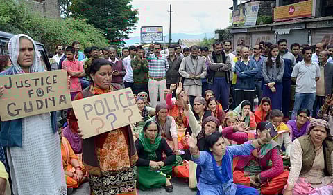 People hold placards block a road during a protest demanding justice for the 16 year school girl who was raped and murdered in Shimla.  (File | PTI)