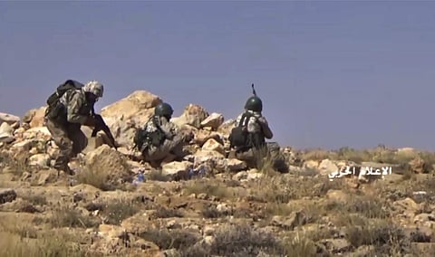 Hezbollah fighters taking position during clashes with al-Qaida-linked militants in an area on the Lebanon-Syria border. | AP