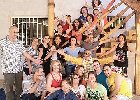 Youssef Majed (centre) set out on his mission to spread happiness after meeting  Sri Sri Ravi Shankar of Art of Living. He has trained 300 people over the last few years