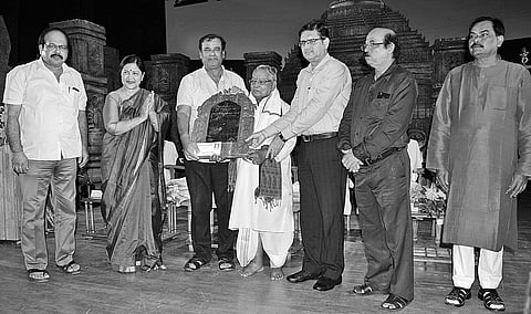 Tourism and Culture Minister presenting Kabi Samrat Upendra Samman to Banamali Maharana in Bhubaneswar on Saturday | Express