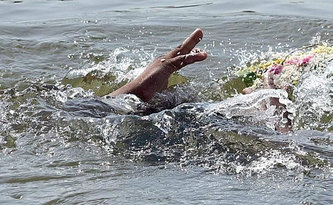 A devotee offers vavu bali in the Periyar at Aluva on Sunday | Albin mathew