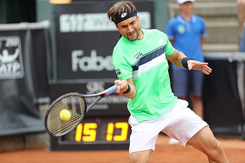 David Ferrer of Spain returns to Alexandr Dolgopolov of the Ukraine during the singles final match of the Swedish Open tennis tournament in Bastad. | AP