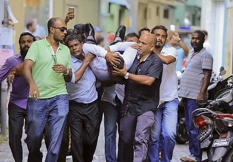 Maldivian lawmaker Faisal Naseem who was injured in clashes with police is rushed to a hospital in Male. | AP
