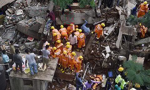 Fire brigade and NDRF personnel carrying out a search and rescue operation following a building collapse at Ghatkopar in Mumbai on Tuesday. (File | PTI)