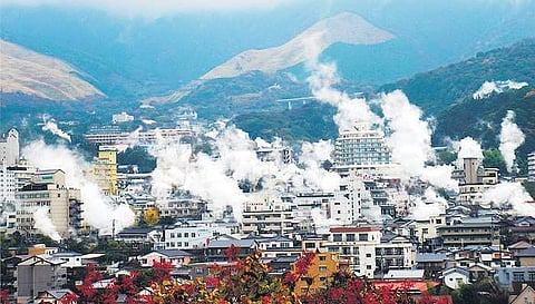 Steam rises from underground geothermal activity in Beppu