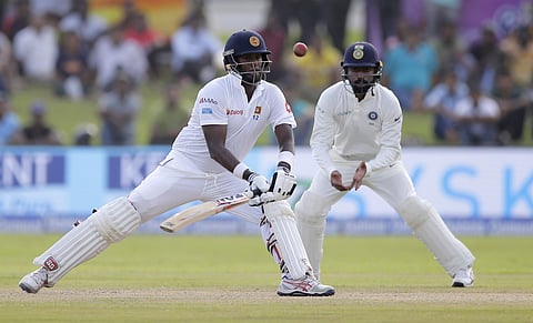 Sri Lanka's Angelo Mathews plays a shot as India's Abhivav Mukund watches during the second day's play of the first test cricket match. (AP)