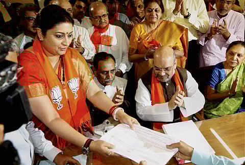 BJP chief Amit Shah, Union minister Smriti Irani and newly inducted former Congress MLA Balwantsinh Rajput, who resigned yesterday and joined the saffron party, today filed their nomination papers. | PTI