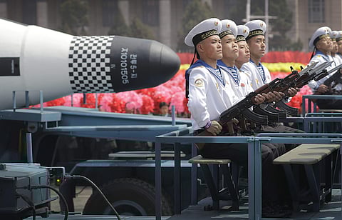 A file photo, navy personnel sit in front of a submarine-launched 'Pukguksong' ballistic missile (SLBM) as it is paraded across Kim Il Sung Square in Pyongyang, North Korea. North Korea’s nuclear and missile programs have without doubt come at a severe co