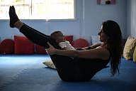 Woman practicing Yoga with her baby | IANS