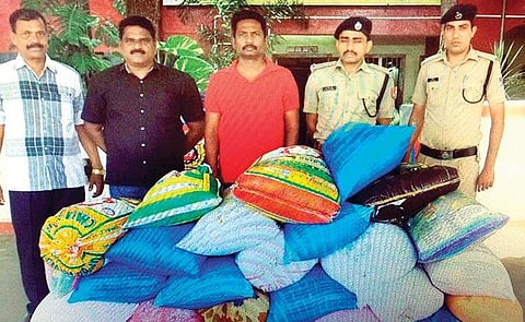RPF and civil supplies department personnel with seized PDS rice bags at Katpadi station | Express