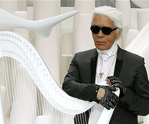 German fashion designer Karl Lagerfeld poses before Chanel's spring-summer 2012 ready to wear collection (AP Photo/Thibault Camus).