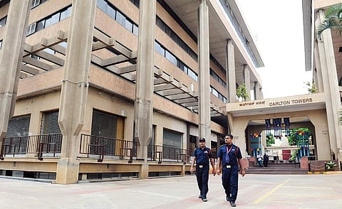 Guards walk past Carlton Towers, which is now open to business establishments | NAGESH POLALI