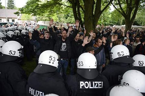 Police officers clear a camp as people protest at a park before the G20 summit in Hamburg, northern Germany, Tuesday, July 4, 2017. (Daniel Reinhardt/dpa via AP)