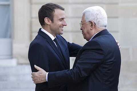 French President Emmanuel Macron, left, greets Palestinian leader Mahmoud Abbas upon his arrival at the Elysee Palace prior to their meeting in Paris, France, Wednesday, July 5, 2017. (AP Photo/Kamil Zihnioglu)